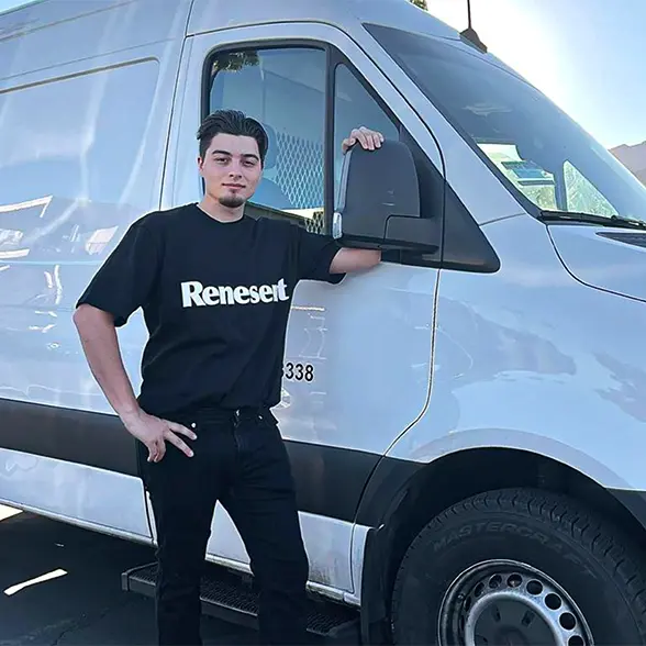 Renesent employee standing by a van ready for relocation services
